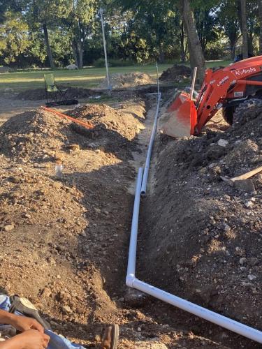our tractor putting sand under water line